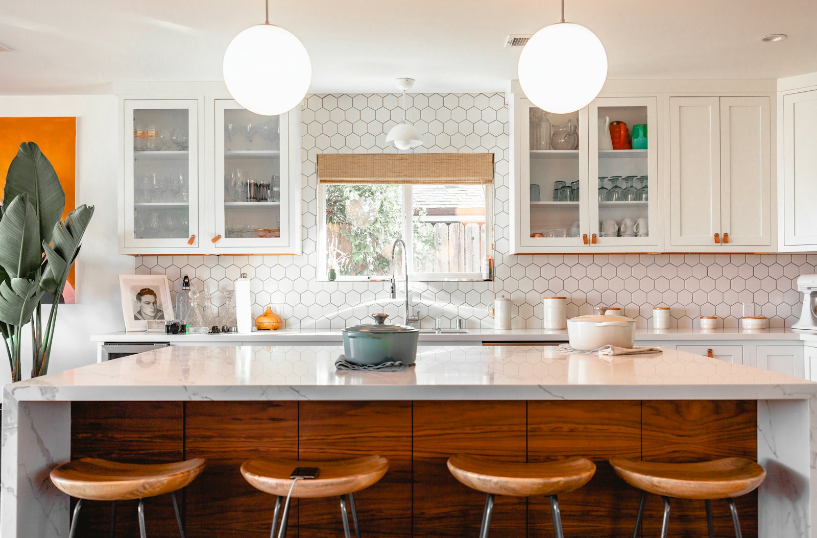 Kitchen island with wood fronts and four counter stools