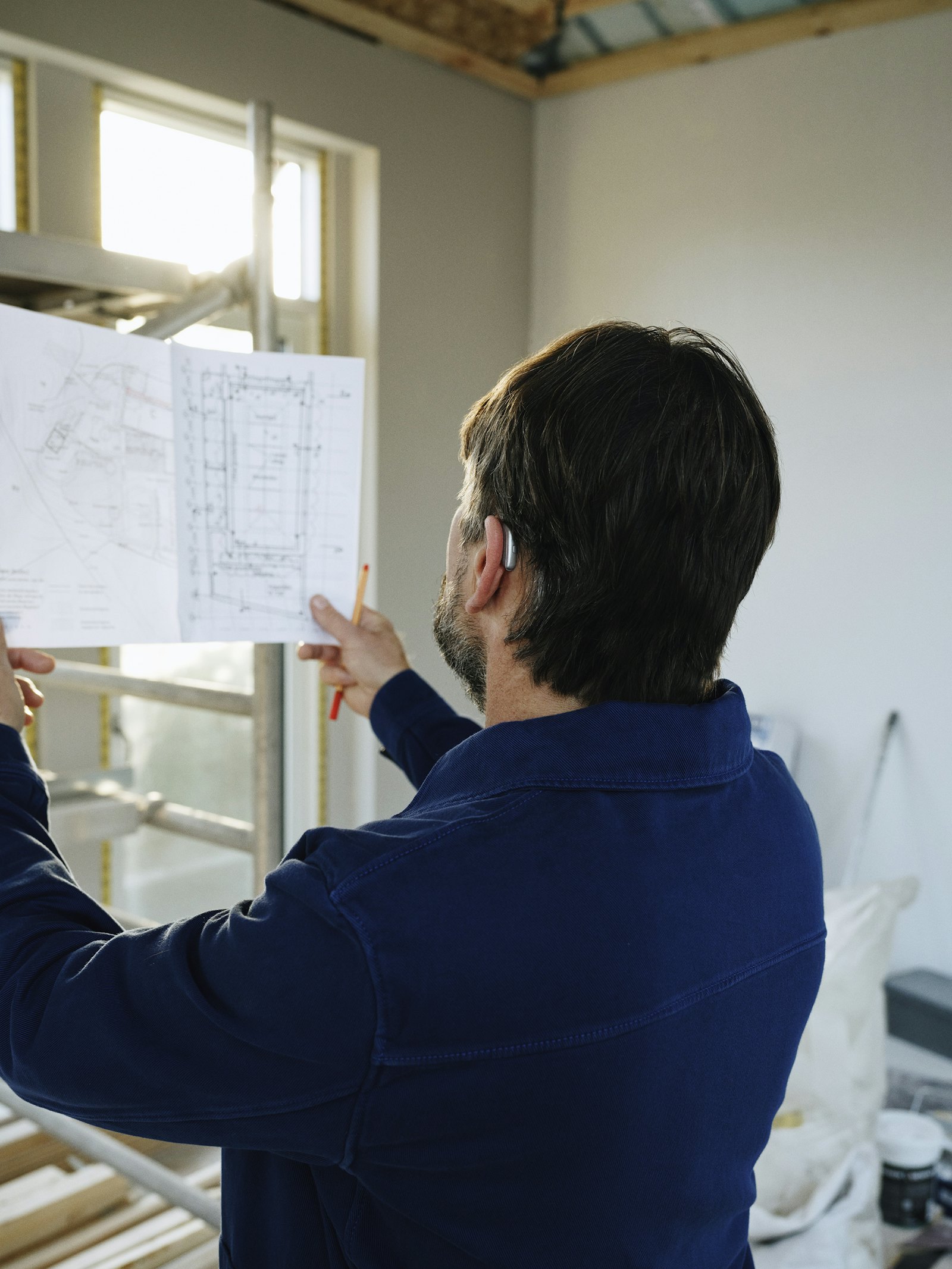 Project lead reviewing drawings on site